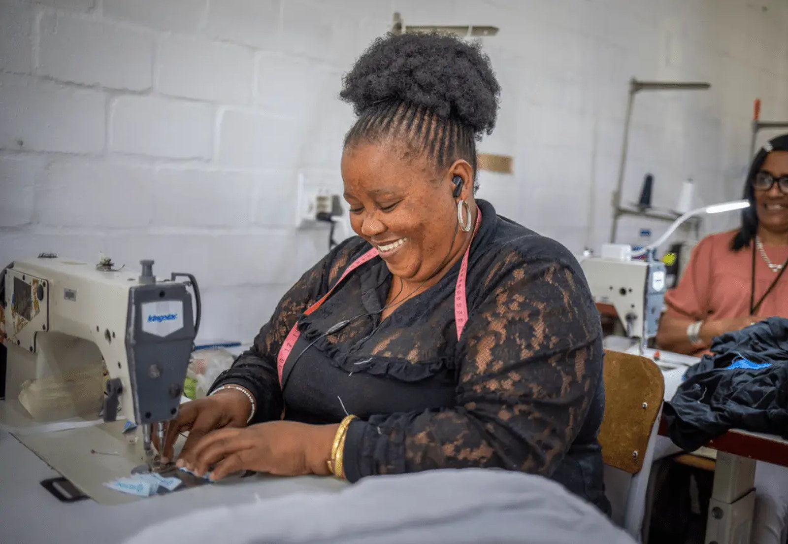 A maker at The Sewing Café hand-stitching a YourTurn board.