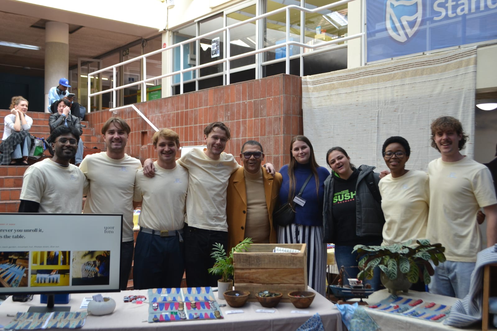 The YourTurn team at the UCT Genesis Expo, boards on the table.